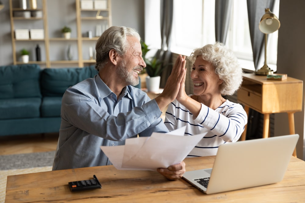 2 elderly people high fiving